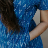 Close-up of a blue Ikat cotton dress with a gathered waist, ethically crafted for timeless, eco-friendly fashion