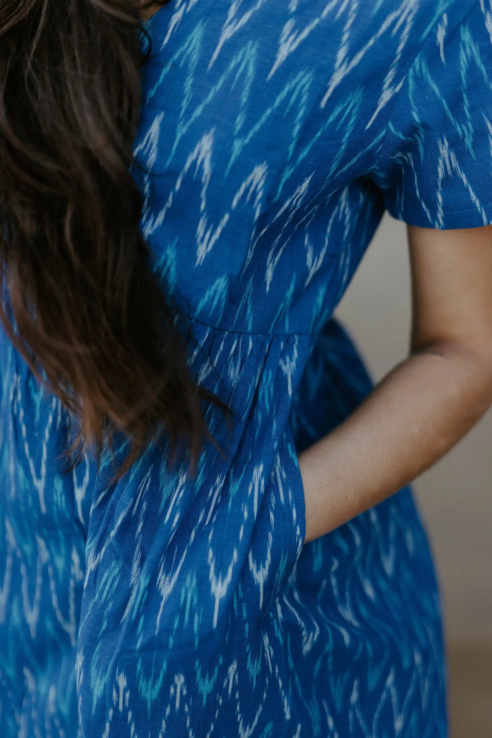 Close-up of a blue Ikat cotton dress with a gathered waist, ethically crafted for timeless, eco-friendly fashion