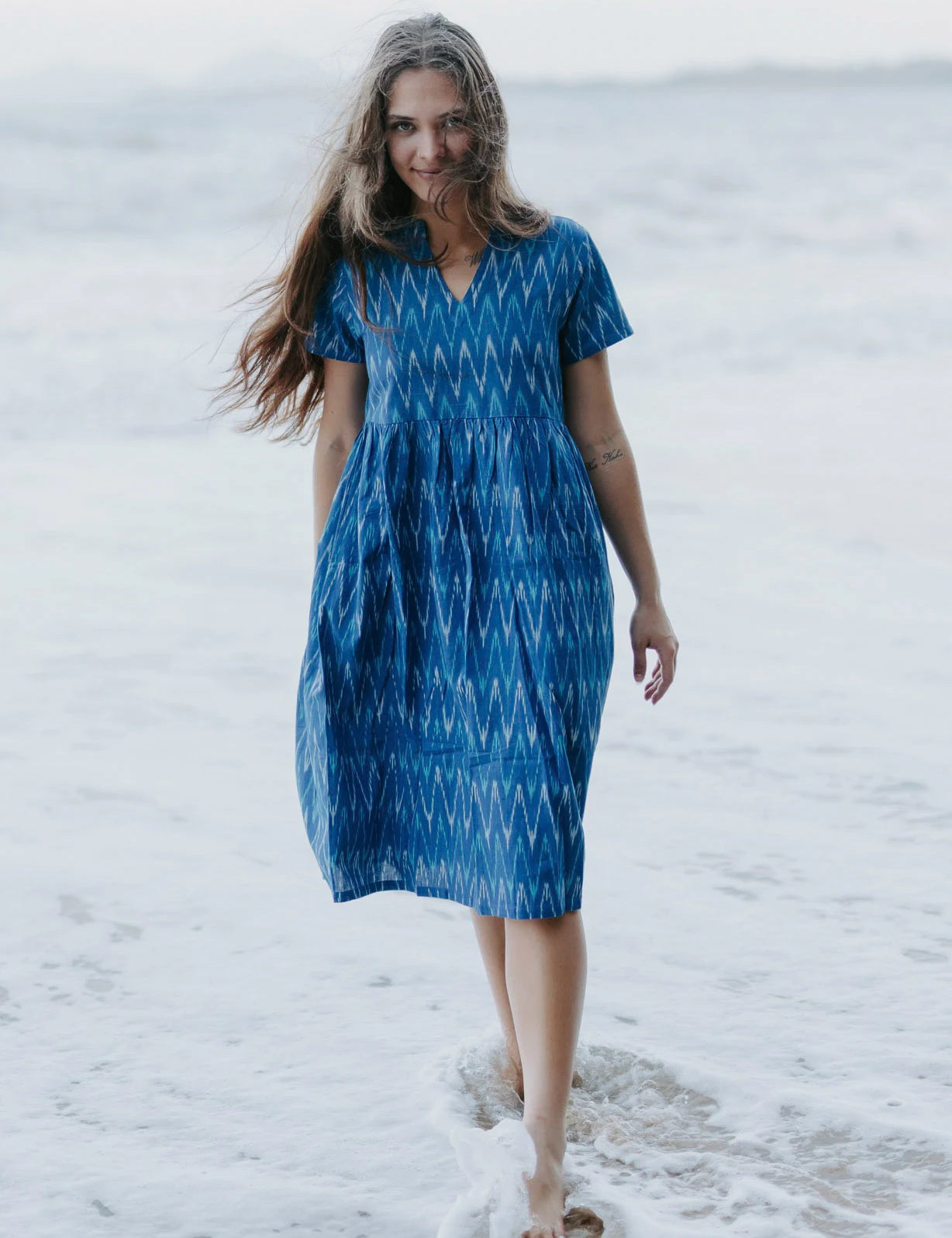 Close-up of a blue Ikat cotton dress with a gathered waist, ethically crafted for timeless, eco-friendly fashion