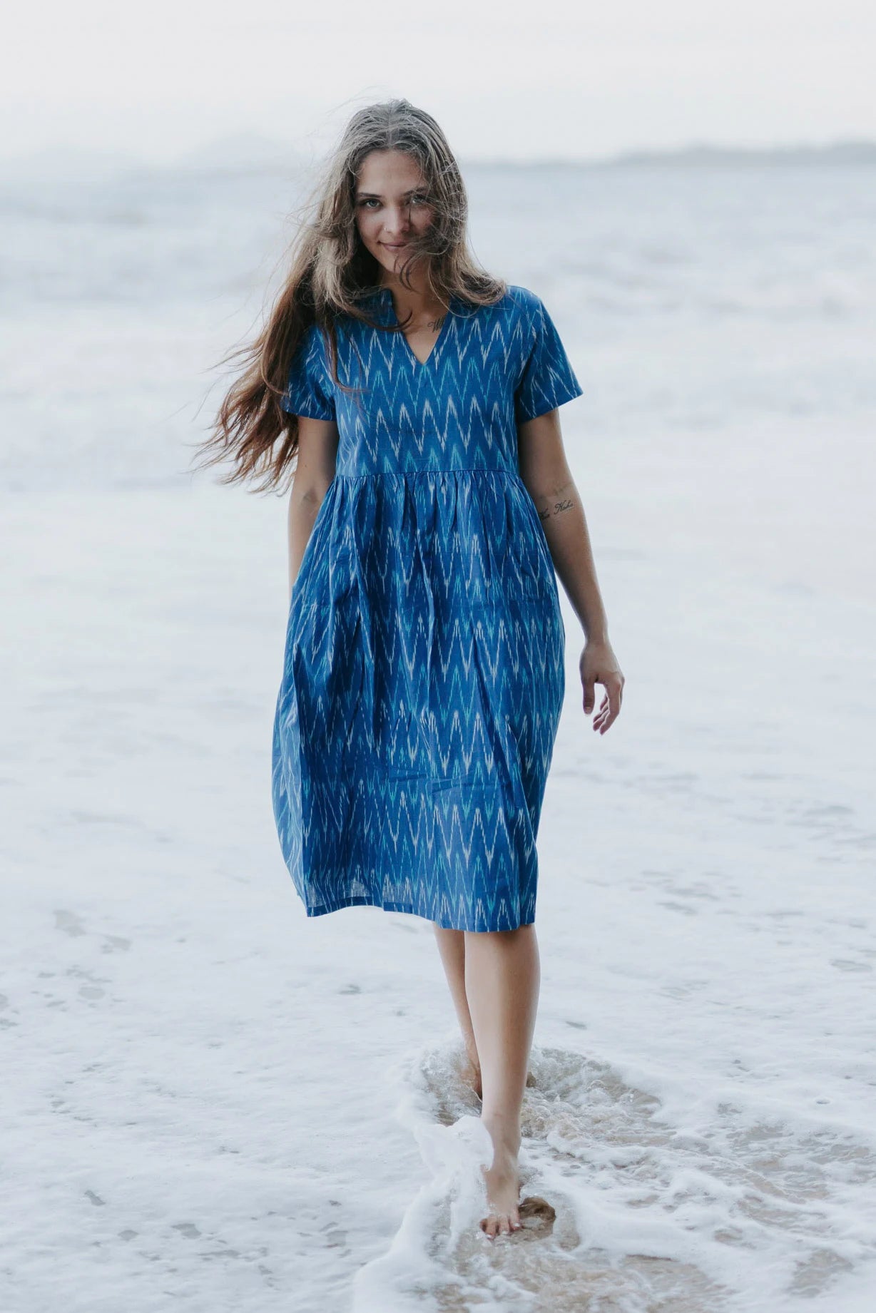 Close-up of a blue Ikat cotton dress with a gathered waist, ethically crafted for timeless, eco-friendly fashion