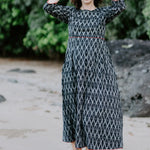 Woman wearing the Melbourne Box Dress in black and white Ikat cotton, standing outdoors.