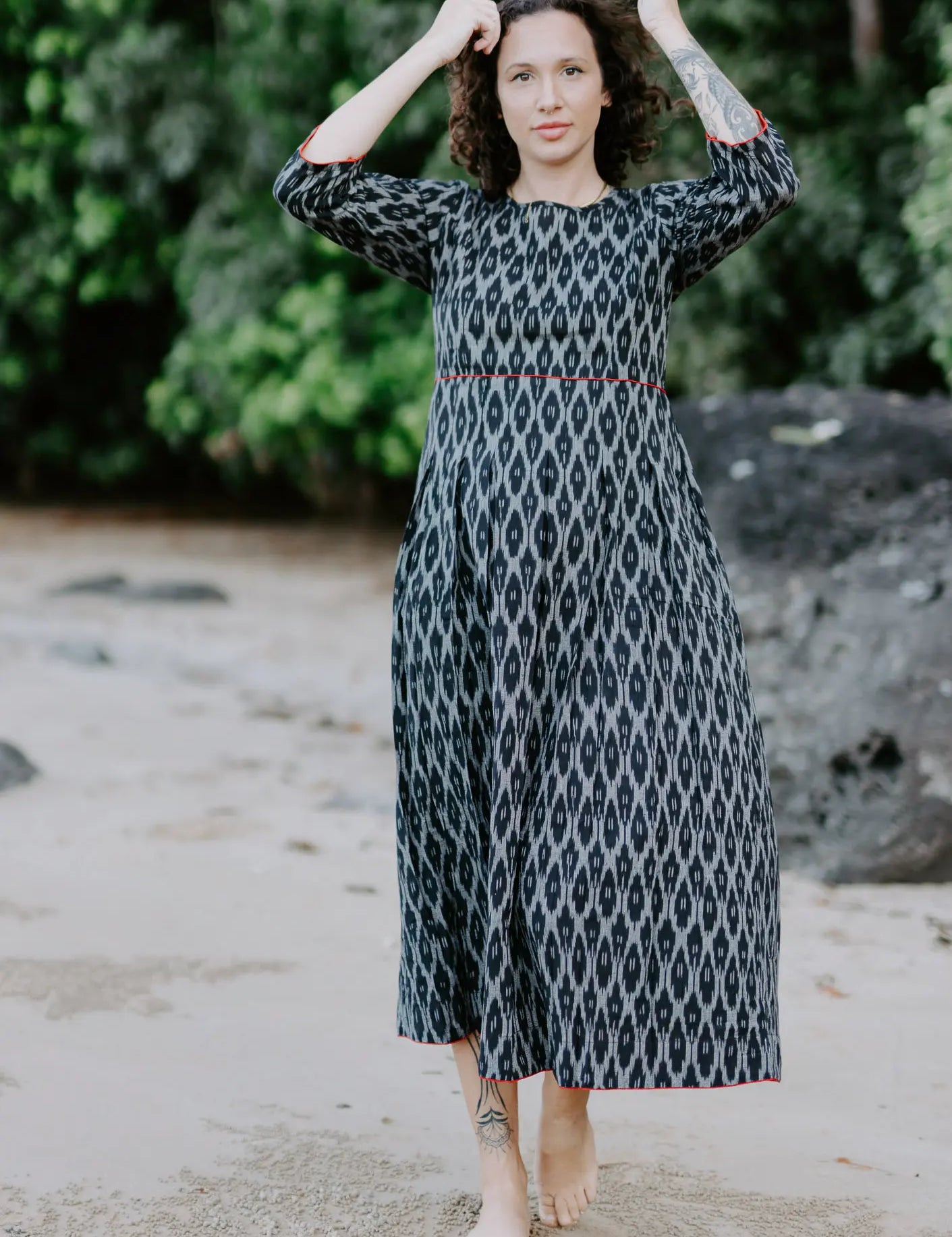 Woman wearing the Melbourne Box Dress in black and white Ikat cotton, standing outdoors.