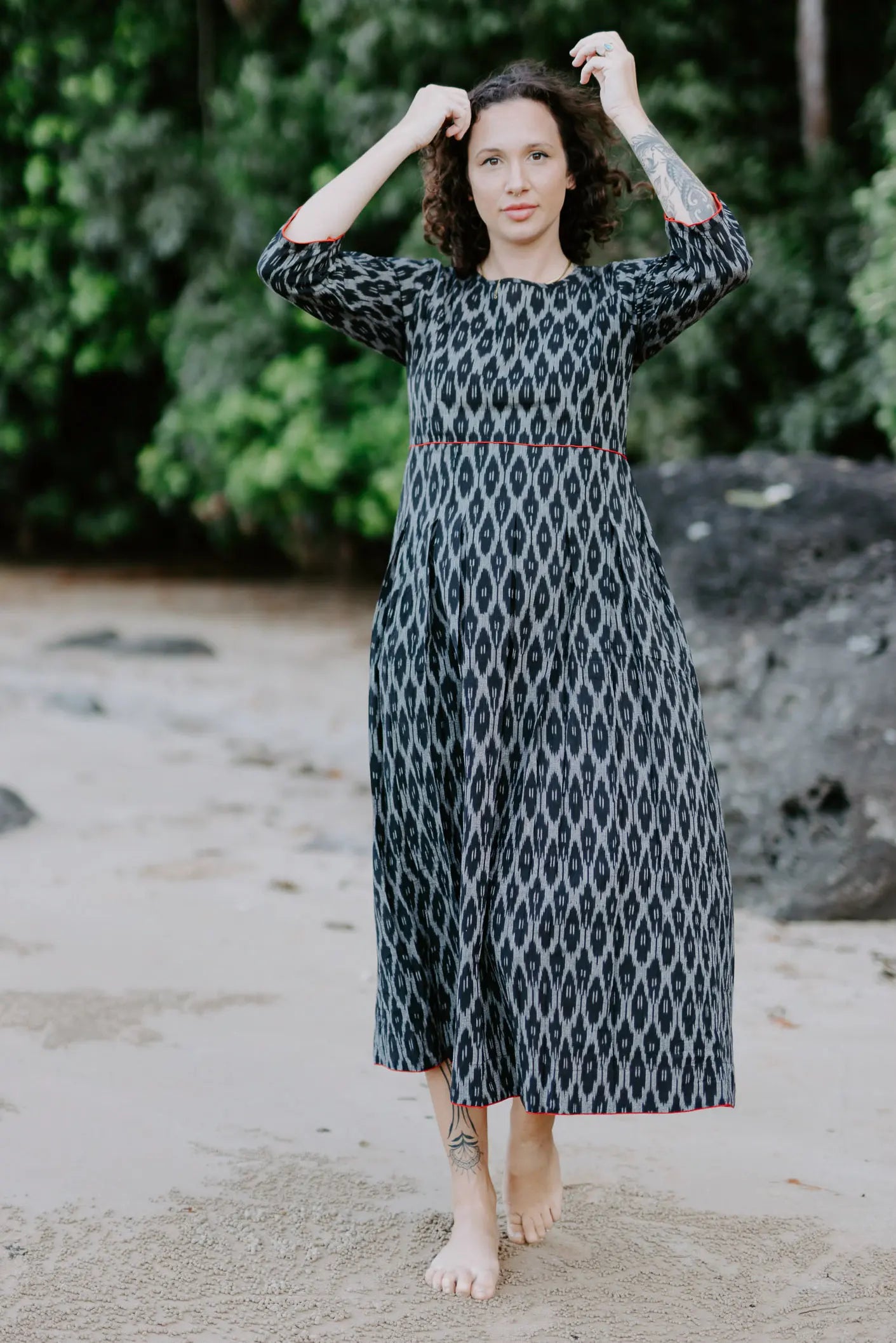 Woman wearing the Melbourne Box Dress in black and white Ikat cotton, standing outdoors.