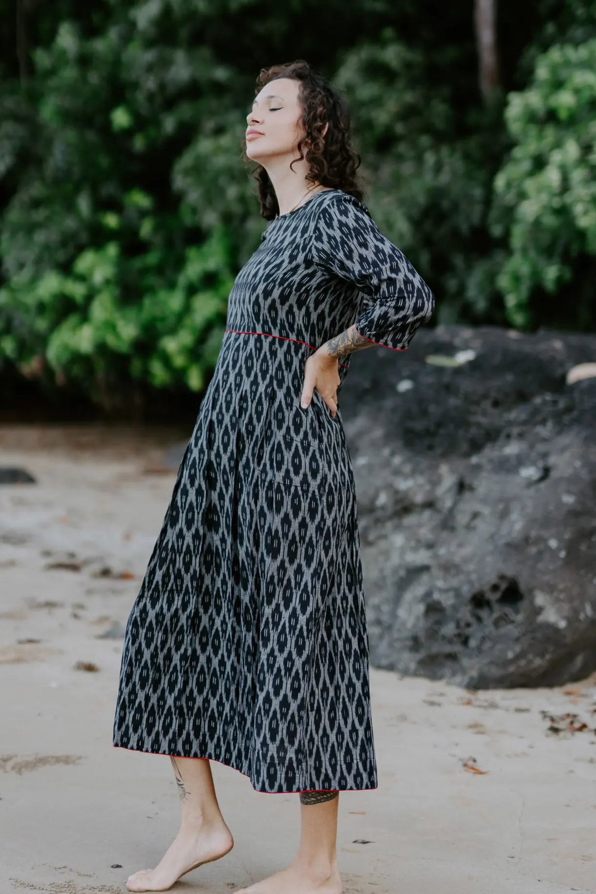 Handwoven black and white Ikat cotton dress with red piping details